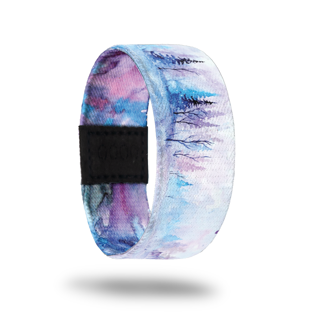 Be Still My Soul-Sold Out-ZOX - This item is sold out and will not be restocked. White snowy background with blue and pink pine trees in the background. Inside is blue, pink and purple watercolor and says Be Still My Soul. 