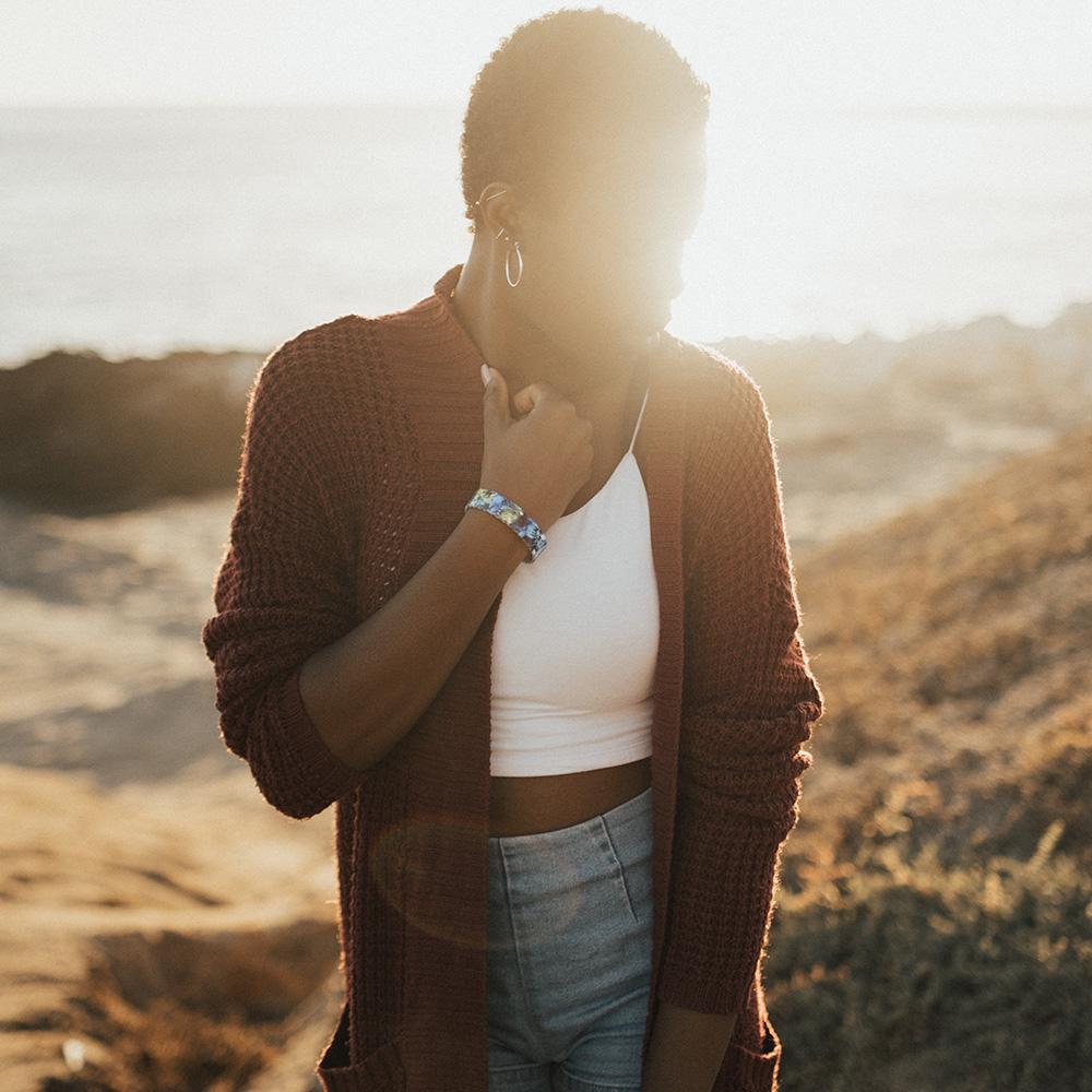 Lifestyle image of someone standing front of a setting sun and wearing My Empire Of Dirt