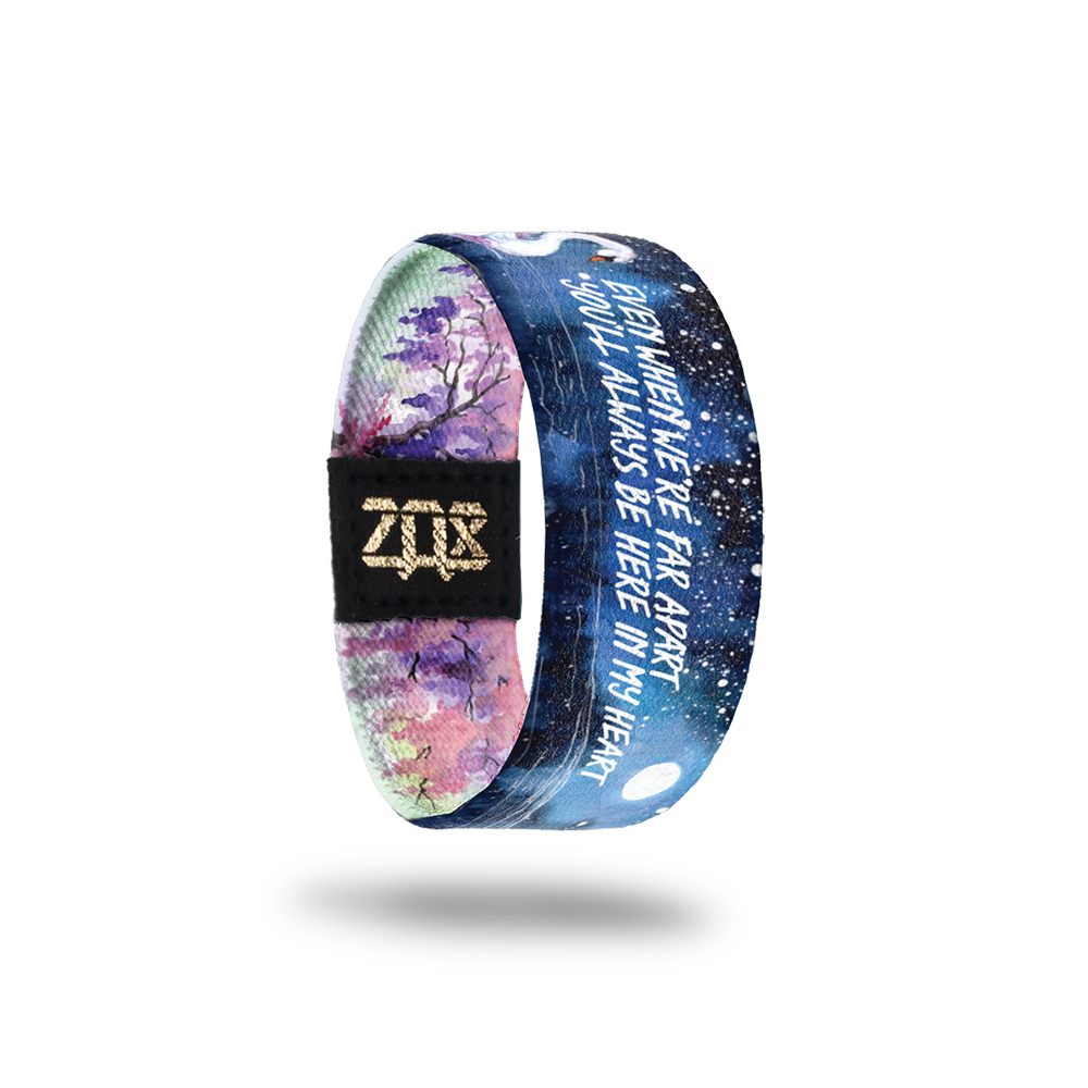 Inside Design of Even When We’re Far Apart kids size: watercolor night sky with a swan swimming in the water and white text in the middle ‘Even when we’re far apart you’ll always be here in my heart’