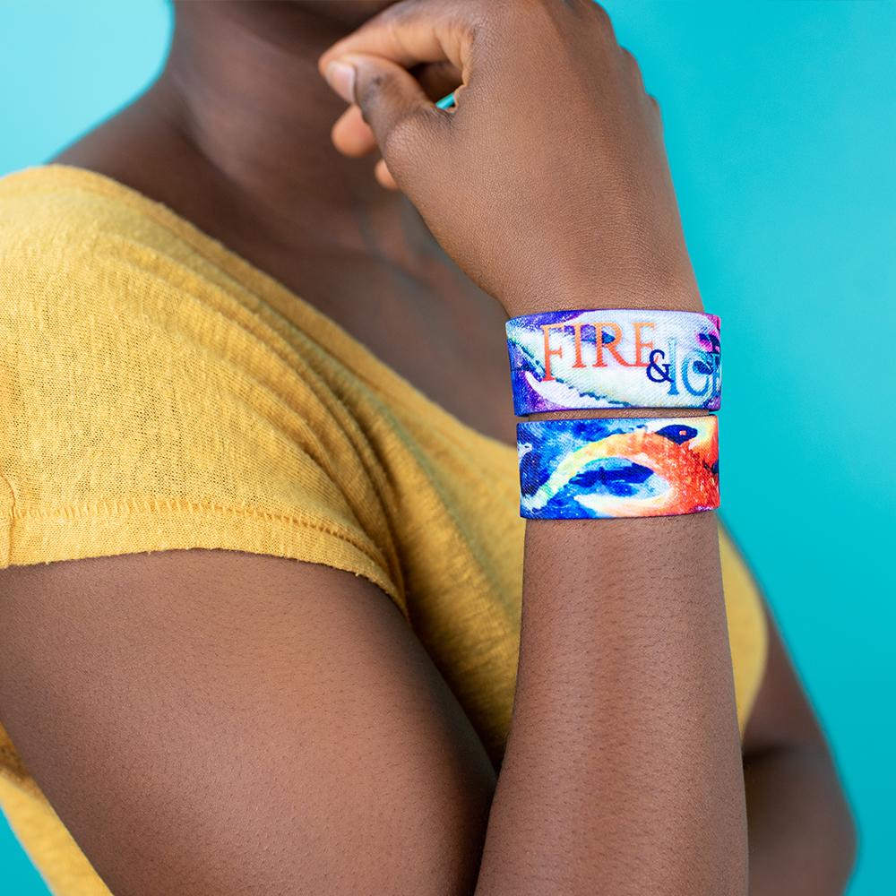 Studio Image close up of 2 Fire & Ice on 1 wrist with arm in thinking pose