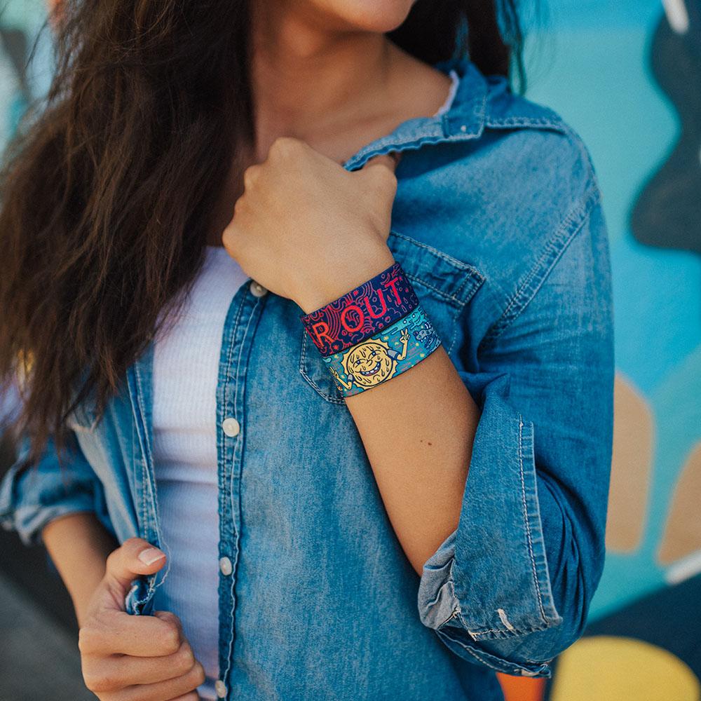 Lifestyle image of someone holding their jacket closed with two Far Out straps on their wrist