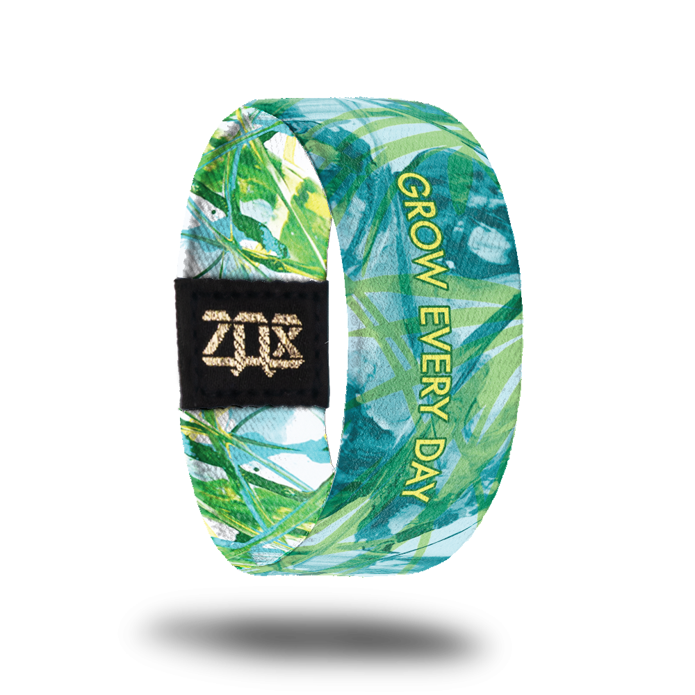 Inside design of Grow Every Day. Illustration of plant life in green and light blue colors with Grow Every Day centered in yellow text