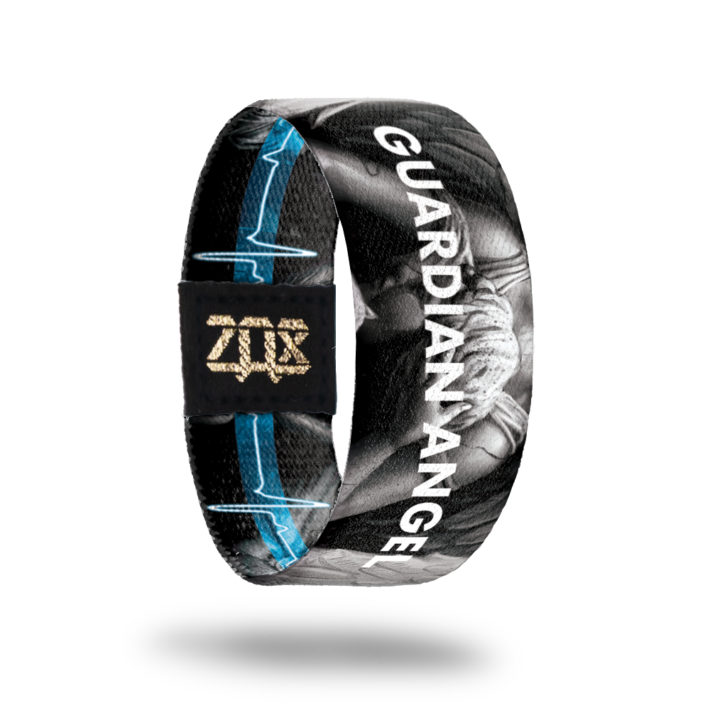 Inside design of Guardian Angel, grayscale angel in the center of black background with Guardian Angel in blue transparent text over the angel