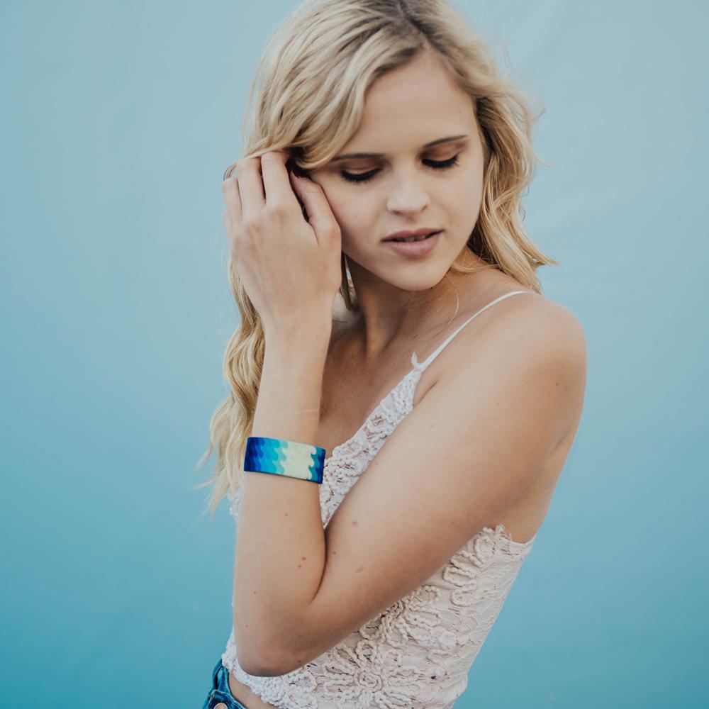 Lifestyle image of women fixing their hair with a Go With The Flow on their wrist