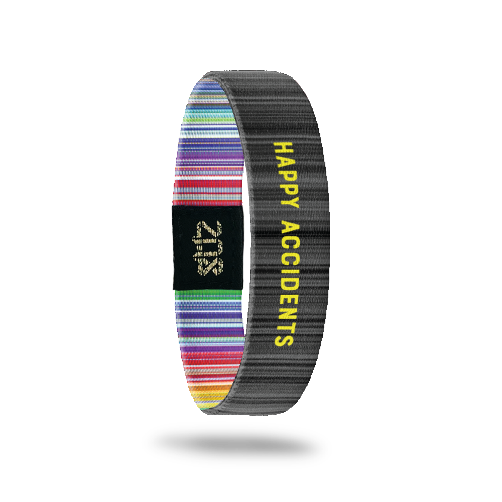 Inside Design of Happy Accidents: dark and light grey striped design with yellow text ‘Happy Accidents’