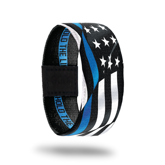 Outside Design of Hold The Line. wavy black and white United States flag with a line of blue for one bottom stripe of the flag