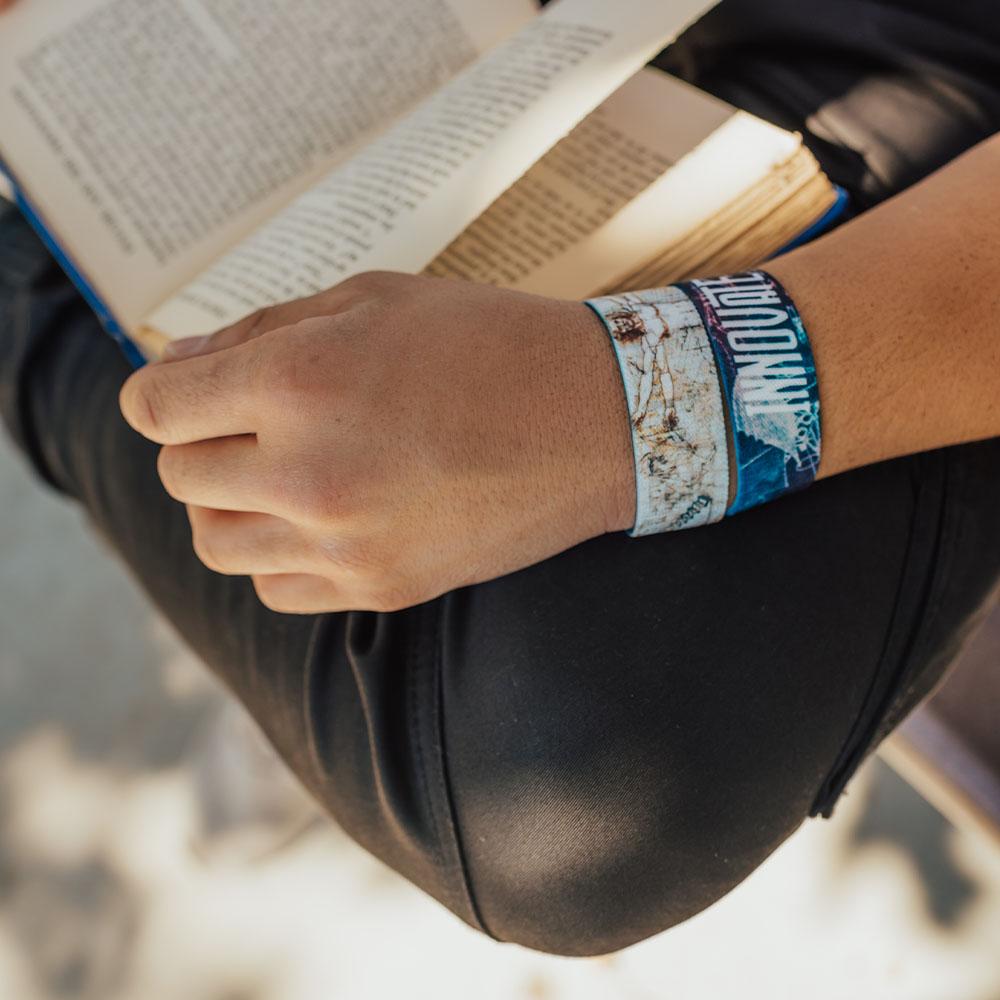 Lifestyle close up of someone reading a book with 2 Innovate straps on 