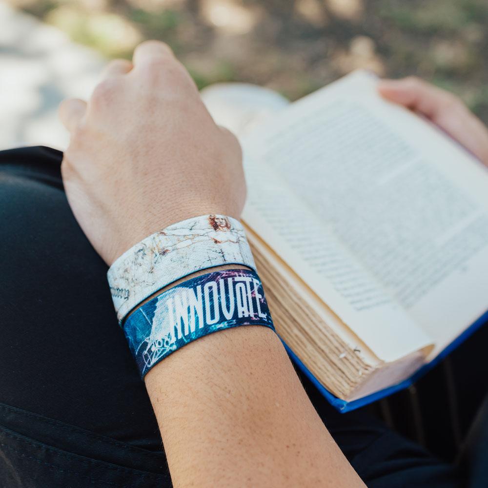 Lifestyle close up of someone reading a book with 2 Innovate straps on 