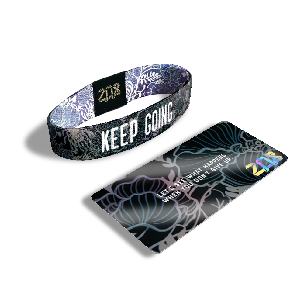 Inside Design of Keep Going: black and grey floral sketch with white text overlaying ‘Keep Going’ with its card that says 'Let's see what happens when you don't give up.'