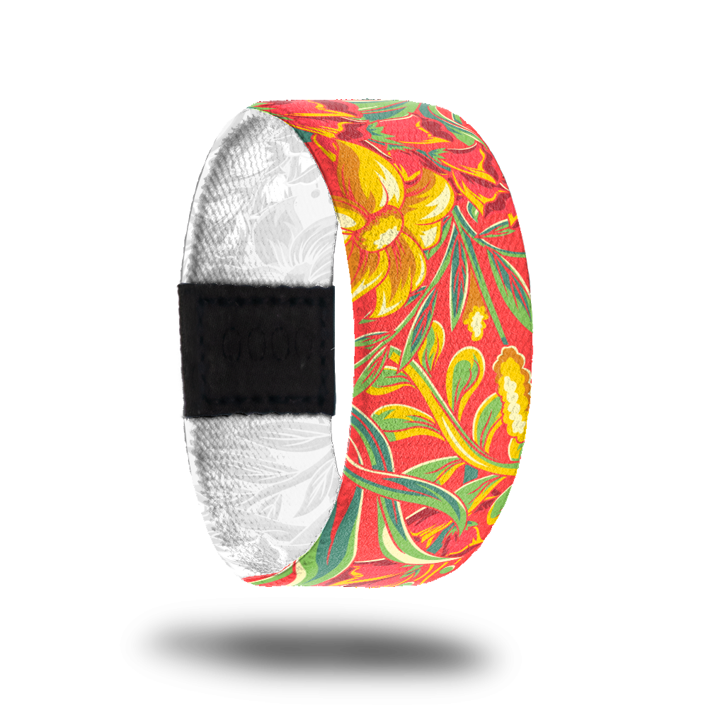 Outside design of Life Is A Gift. Orange-red background with golden colored flowers and green leafs and green stems