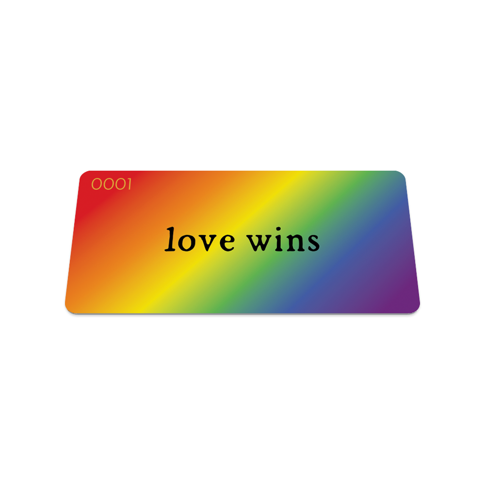 Front collector's card image of Love Wins: rainbow gradient with black text ‘Love Wins’ on strap