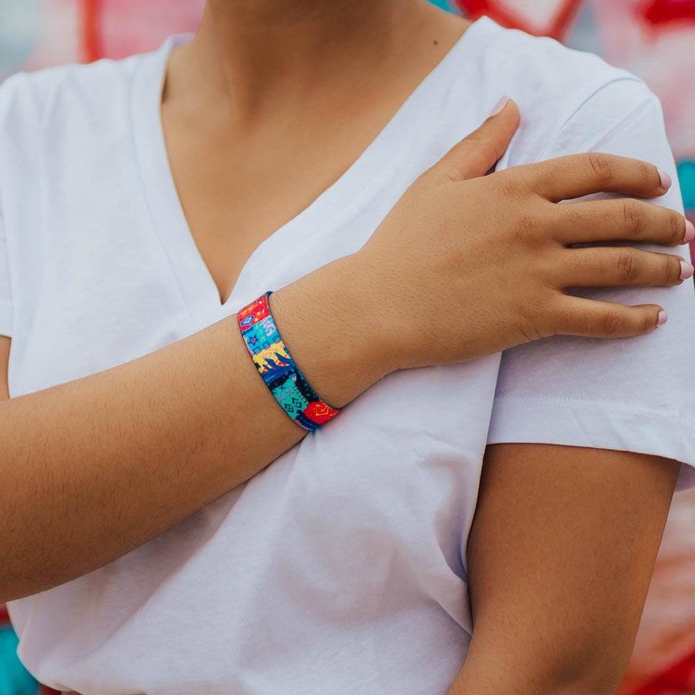 Lifestyle photo of wrist wearing live with joy showing the outside design with hand drawn geometric and abstract art