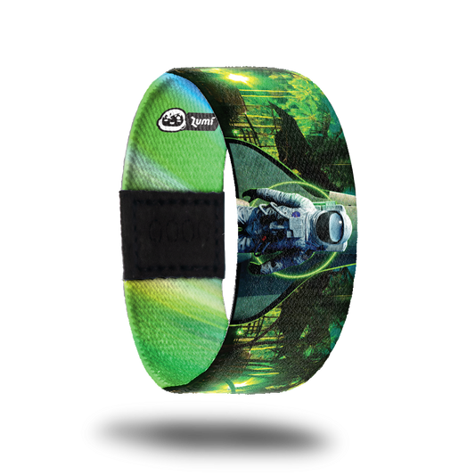 Outside design of Make It Real. Green tinted forest scene with a life image of an astronaut in front of part of a space shuttle