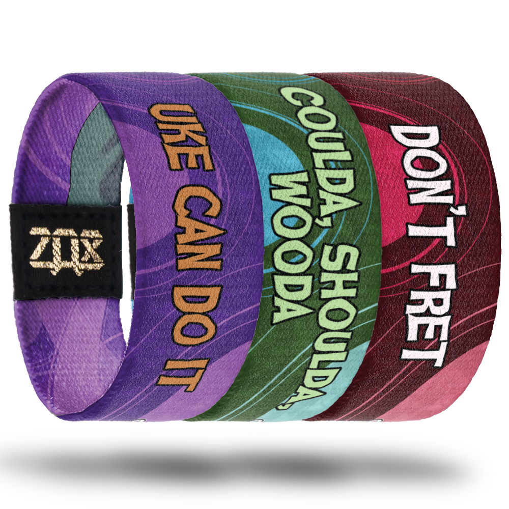 Inside of the purple one says Uke Can Do It. 
Inside of the green one says Coulda, Shoulda, Wooda. 
Inside of the red one says Don't Fret. 