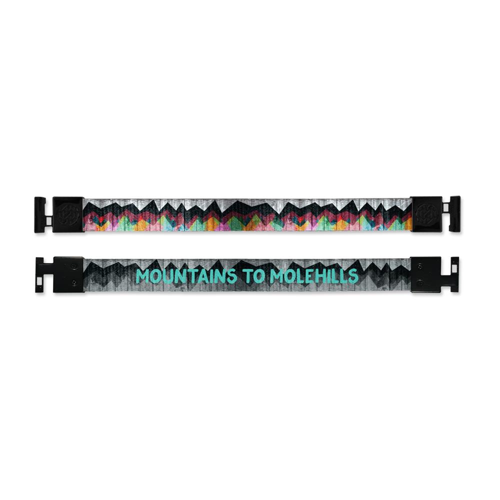 Shows outside and inside design for Mountains To Molehills imperial with black aglet clasps. Top is the outside design, of a painted colorful mountain range over a grey wood texture. Bottom is the inside design, a black and grey depiction of the outside with Mountains To Molehills in light blue text