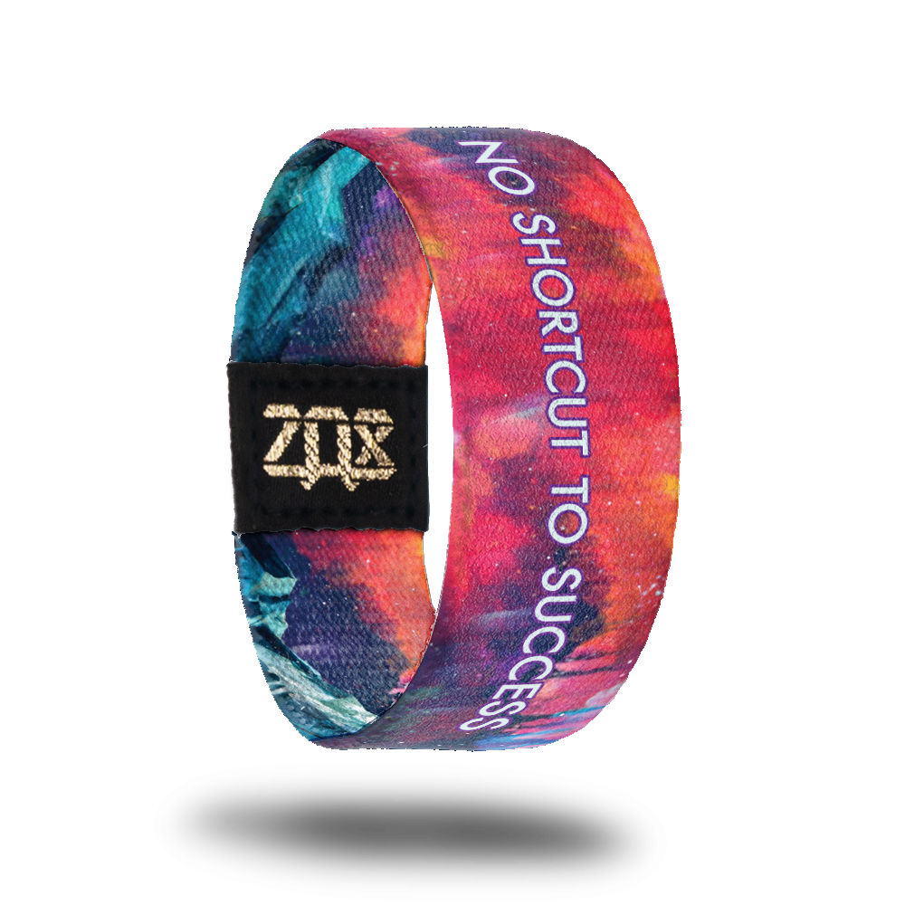 Inside design of No Shortcut To Success. A blended background of pink, orange, and light purple. Centered on the design is No Shortcut To Success in white text with a purple outline around the letters