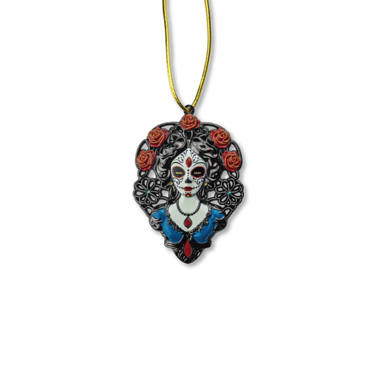 A decorative ornament featuring a stylized, black and white illustration of a female figure with floral accents and a red dress, against a gold-colored background.