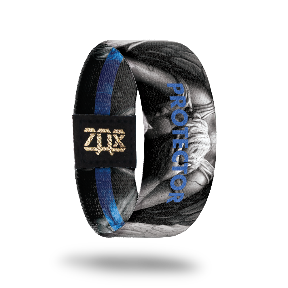 Inside design of Protector, grayscale angel in the center of black background with Protector in blue transparent text over the angel