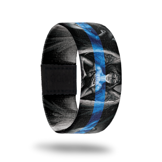 Outside design of Protector, gray scale statue of an angel in the center and two other angels next to the centered angel with a black background. With a blue transparent line centered across the design.
