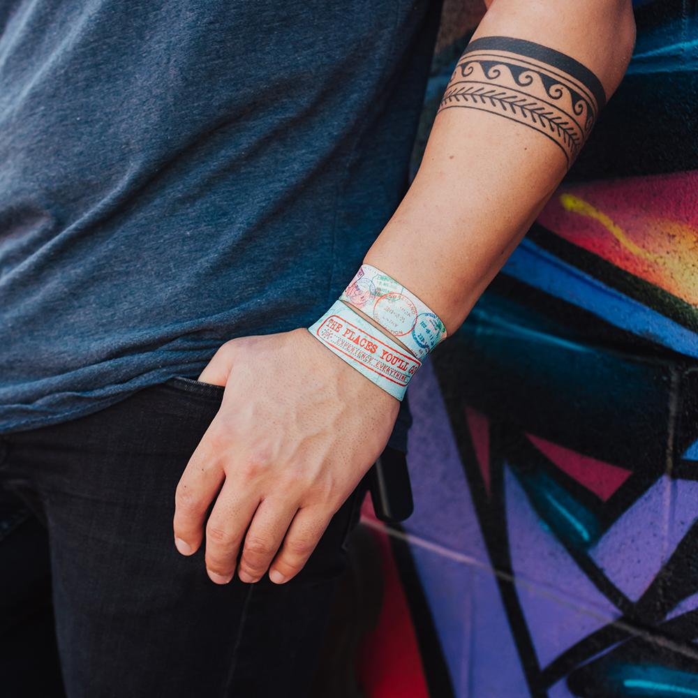 Lifestyle photo of guy with hand in his pocket wearing two The Places You'll Go straps showing the inside and outside design