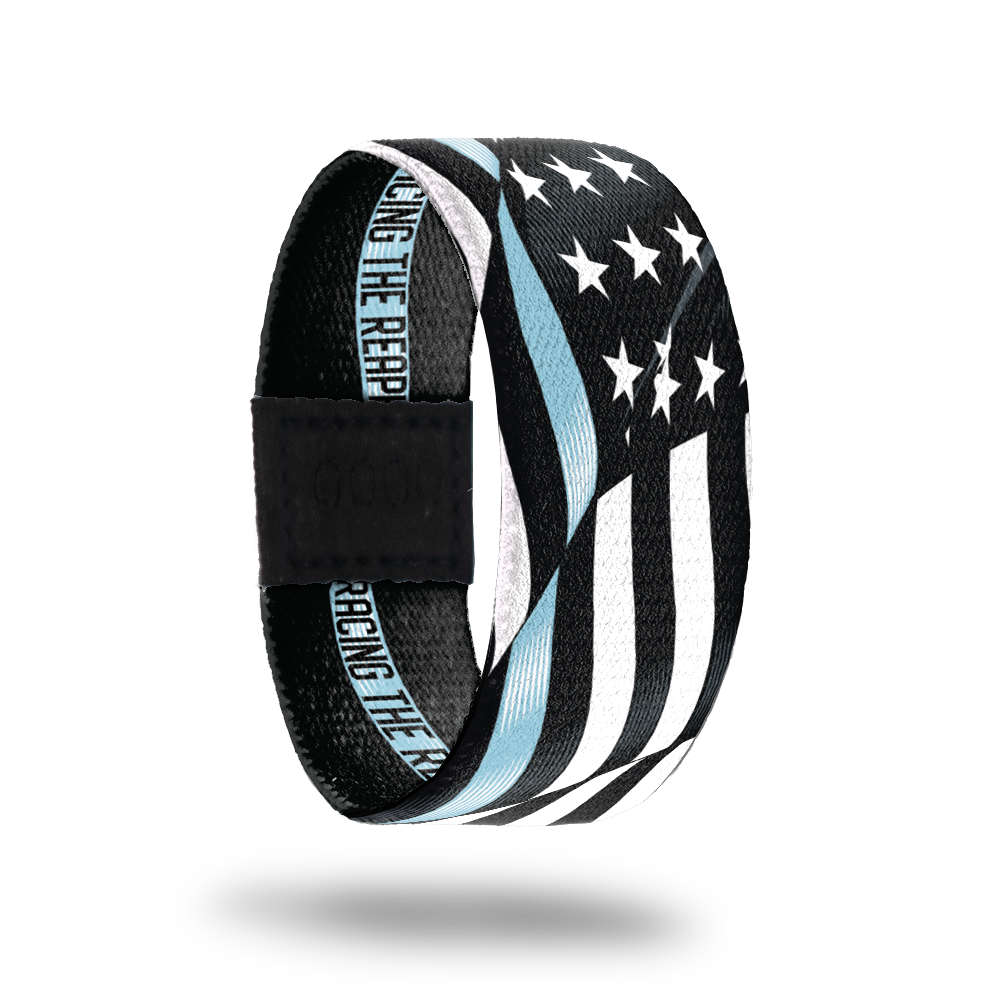 Outside Design of Racing The Reaper. A wavy black and white United States flag with a line of light blue for one bottom stripe of the flag