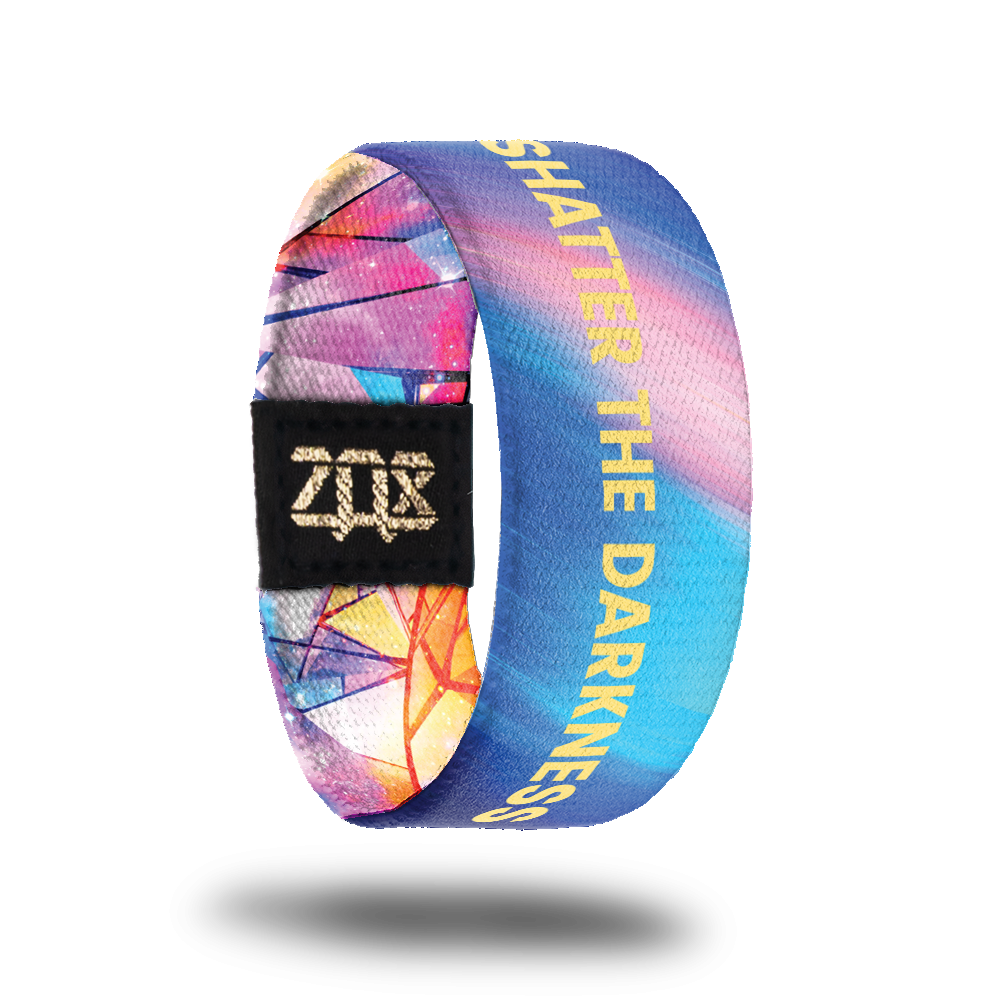 Inside design for Shatter The Darkness. Blended background of light pink and blue with Shatter The Darkness in yellow text in the center