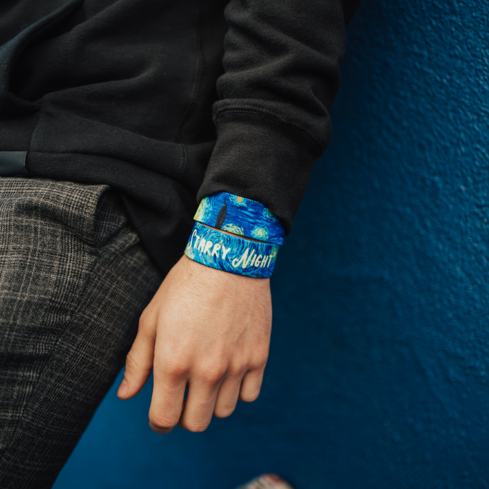 Lifestyle close up image of model's wrist wearing 2 Starry Night straps