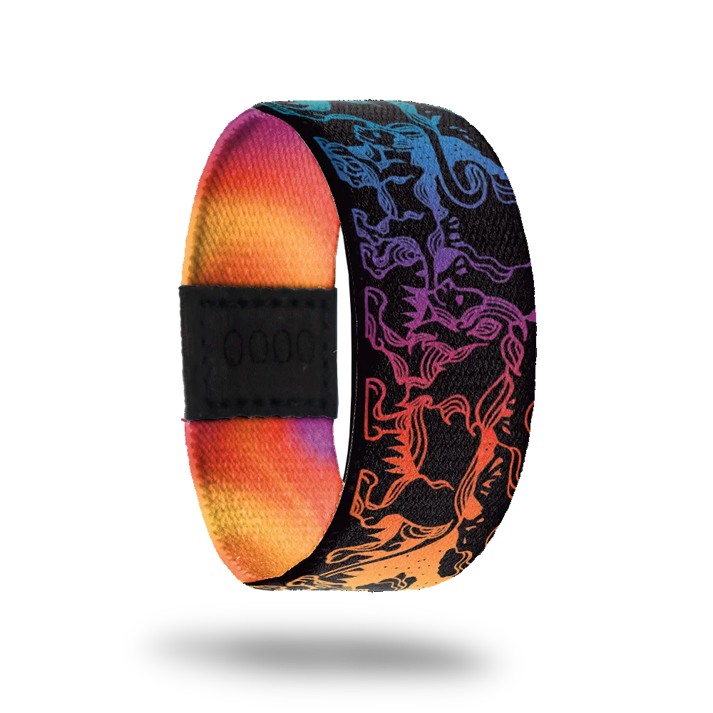 Strap that is all black and has a gradient rainbow design of lions all over. The inside is all rainbow gradient and reads Stand Proud.