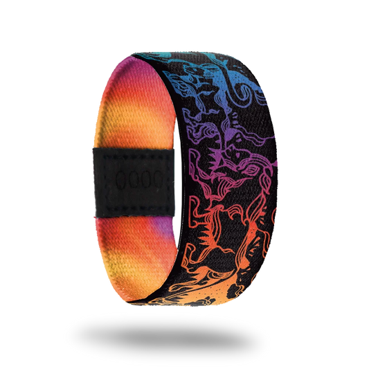 Strap that is all black and has a gradient rainbow design of lions all over. The inside is all rainbow gradient and reads Stand Proud.