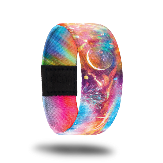outside design for Stay Strong. Unique light space design with orange, pink, and blue. A partial moon in the center and some flowers on the sides