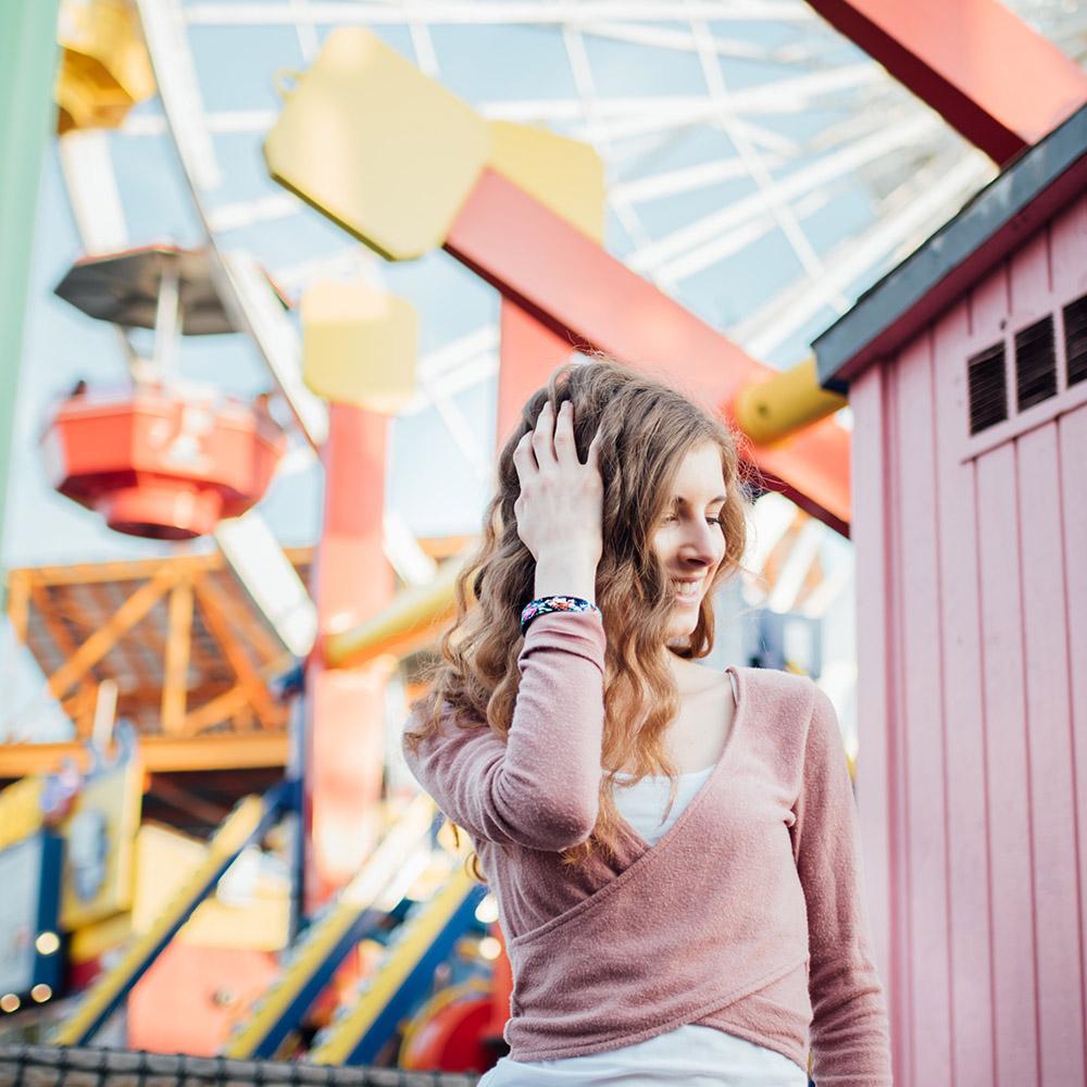 Lifestyle image of someone in front of a ferris wheel wearing Stronger With Every Struggle