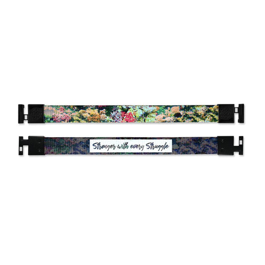 Shows outside and inside design for Stronger With Every Struggle imperial with black aglet clasps. Top is the outside design, a realistic image of a collection of colorful plant life. Bottom is the inside design, with a black background and a white box in the center with Stronger With Every Struggle in black text.