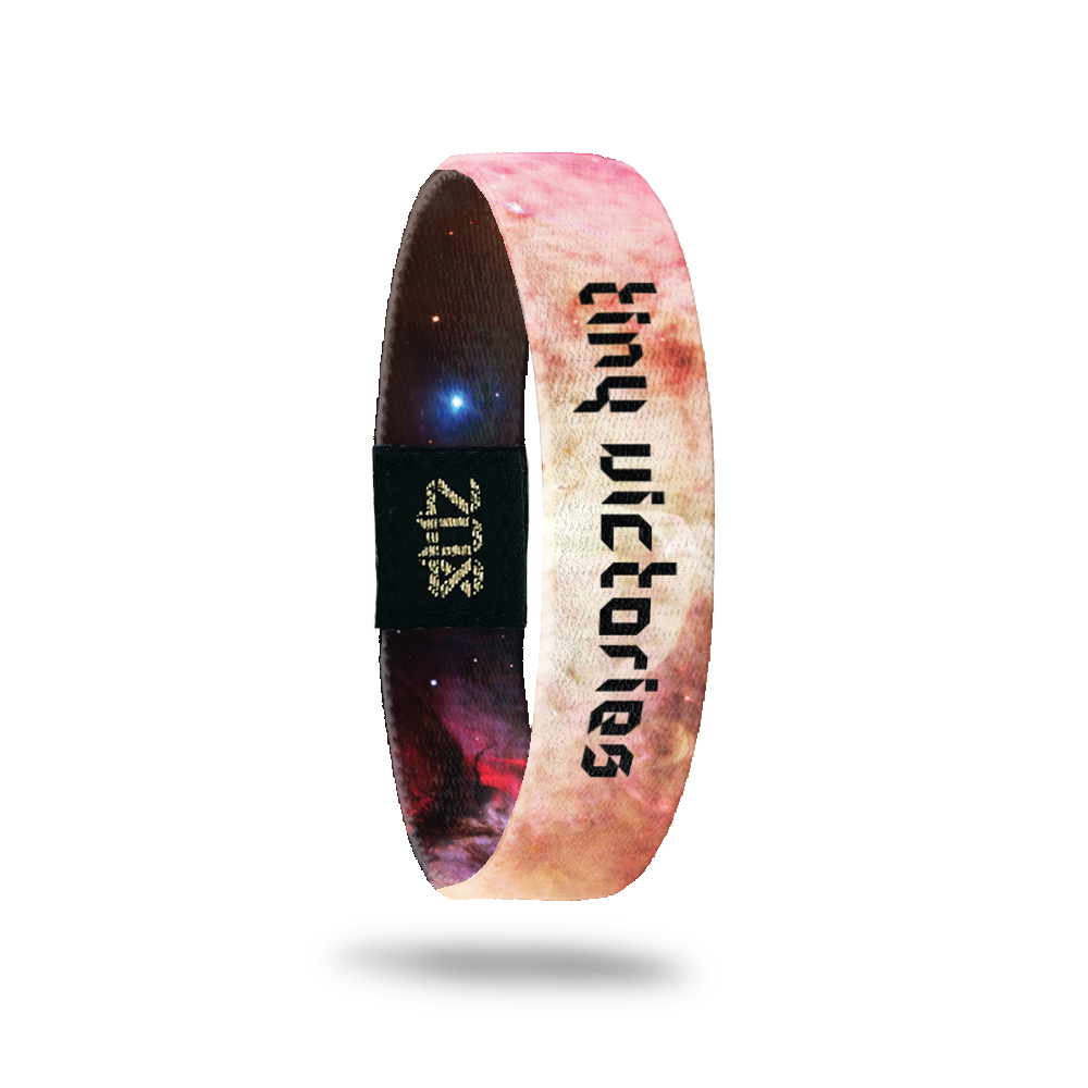 Inside Design of Tiny Victories: light pink, tan, light purple, and white galaxy with black digital text overlaying 'tiny victories'