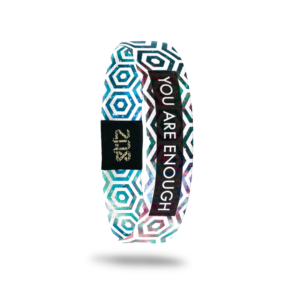 Product photo of the inside of you are enough. It is a white hexagon pattern overlaying a pink, blue, green, and purple galaxy design with white you are enough text over black box